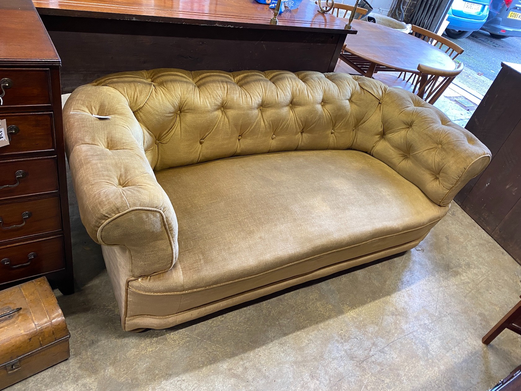 An early 20th century buttoned Chesterfield settee on flat bun feet, length 176cm, depth 82cm, height 66cm